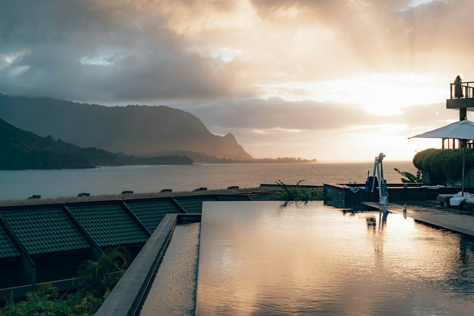 A large swimming pool next to a large body of water
